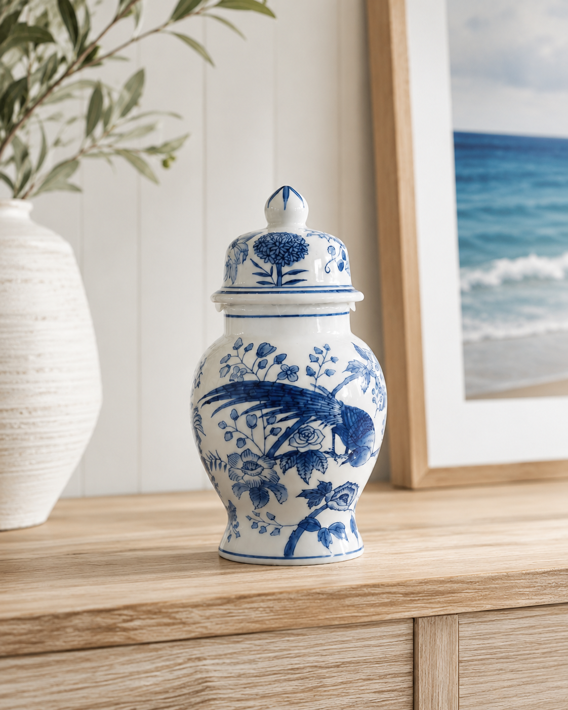 Blue and white ceramic vase and ginger jar set styled on a timber console in a coastal home