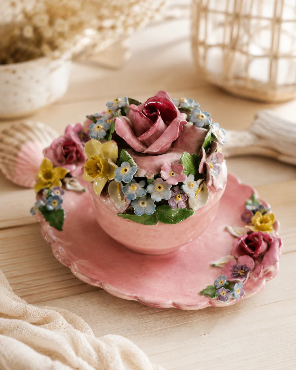 Vintage pink floral keepsake jar styled on a light timber console