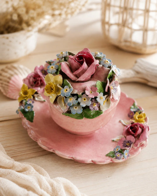 Vintage pink floral keepsake jar styled on a light timber console