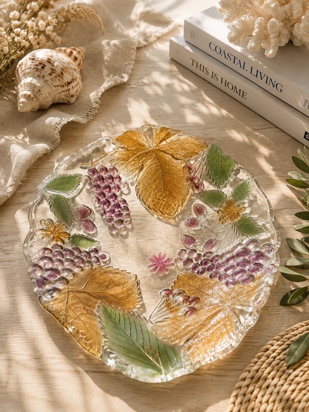 Decorative grape and leaf glass bowl styled on a timber table in a bright coastal home