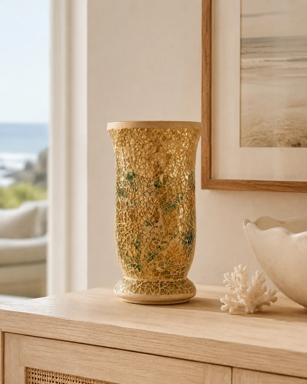 Gold mosaic statement vase styled on a timber console in a neutral coastal home